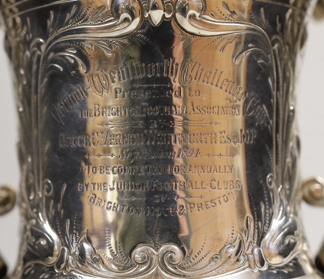 FOOTBALL INTEREST- A late Victorian silver two handled presentation trophy cup, embossed with footballers and inscribed ' Vernon Wentworth Challenge Cup, presented top The Brighton Football Association by Bruce c. Vernon